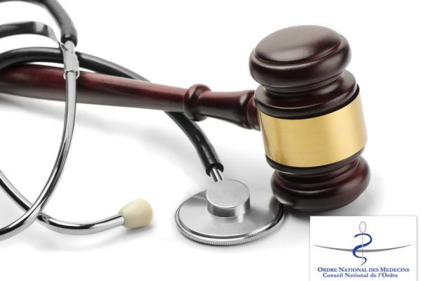 24020312 - close up of stethoscope and gavel on white background